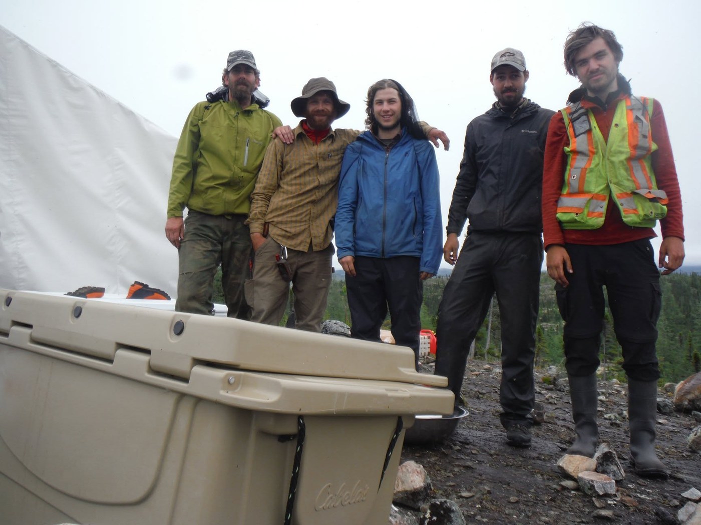 Five of us at the Labrador camp, muddy, wet, and grinning after a day on the lines. Two months, a crew of five, and every kind of weather.