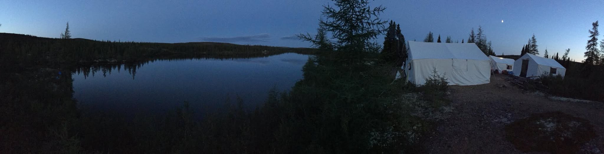 The Labrador camp at dusk: wall tents on a lake, 30 km into the interior. Two months here with a crew of five.